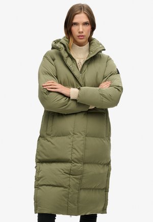Olive green puffer coat with a hood, long design, snap buttons, and contrasting stitching. Features side pockets and a relaxed fit.