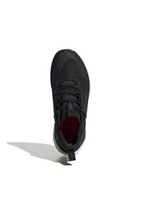 Black athletic shoe with a textured upper, sturdy lacing system, pull tab, and a contrasting red logo on the interior sole. Rubber outsole.