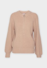Beige knitted sweater with a high neck, front zipper with a round pull, and ribbed cuffs and hem. Features a relaxed fit and textured fabric.