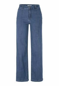 Kapelevt farkut keskisinisessä deniinissä, joissa on korkea vyötärö, näkyvät ompeleet ja sileä pinta. Klassinen viiden taskun muotoilu.