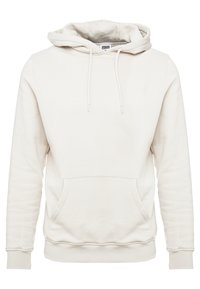 Kremfarget hettegensere laget av mykt stoff, med en stor frontlomme, snorhette, ribbestrikkede mansjetter og kant. Enkelt design, uten mønstre.