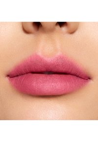 Rouge à lèvres mat d'un rose doux, appliqué uniformément sur des lèvres pleines avec une texture lisse, mettant en valeur les contours naturels des lèvres.