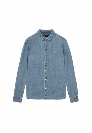 Vaaleansininen farkkupaita, jossa on pitkät hihat, napillinen kaulus ja etunapitus. Rinnassa on pieni koristeellinen logo.