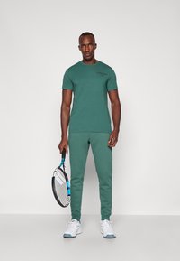Björn Borg ESSENTIAL PANTS - Donji dijelovi trenirke - bistro green