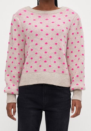Light pink knitted sweater with large pink polka dots, round neck, and ribbed cuffs and hem. Soft texture and relaxed fit.