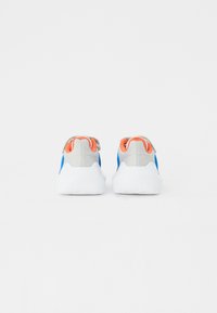 Baskets de sport avec une tige en maille grise, des accents latéraux bleus et un onglet de talon orange. Semelle blanche avec une texture antidérapante et un design rembourré.