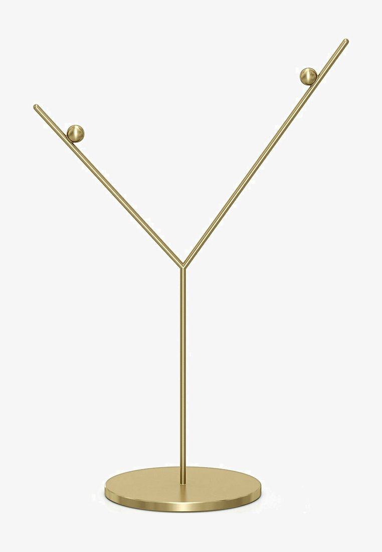 Zlatý kovový stojan na šperky s okrúhlou základňou a naklonenými ramenami, ktoré majú na koncoch dve dekoratívne gule na vystavovanie doplnkov.