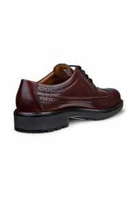 Bruine leren dresschoenen met brogue-details, ronde neus en zwarte rubberen zool. Voorzien van veters en een subtiele glans. Geschikt voor formele gelegenheden.