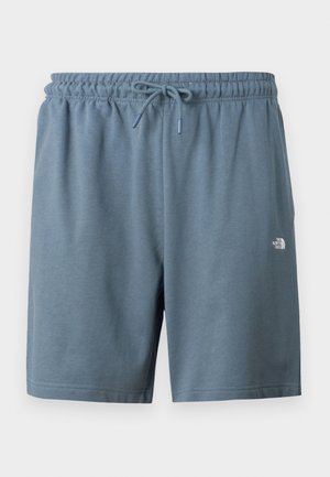 Sinised elastse vöökohaga lühikesed püksid, millel on nöör ja väike valge North Face'i logo vasakul reiel.