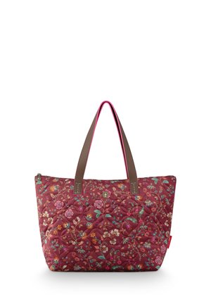 Quilted tote bag with floral pattern in red tones, brown handles with pink edges, and zip closure at the top.