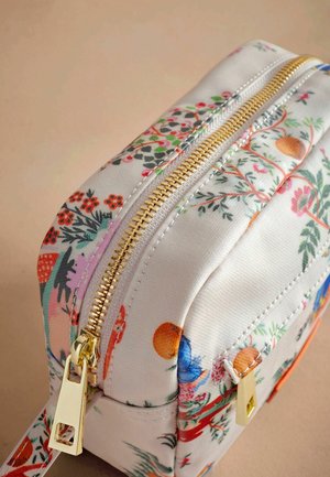 Zippered cosmetic bag featuring a floral print in various colors on a light fabric, with gold hardware and a structured shape.