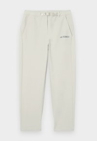 Pantalon outdoor beige clair avec poches latérales, ceinture réglable à boucle et logo Terrex gris sur la partie haute de la cuisse droite.