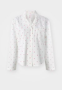 Camicia bianca a maniche lunghe con motivo a cuori rossi, chiusura a bottoni e una tasca sul petto. Realizzata in tessuto leggero con una finitura testurizzata.