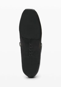 Black leather shoe sole with a smooth finish, a prominent toe shape, and decorative lacing details near the back.