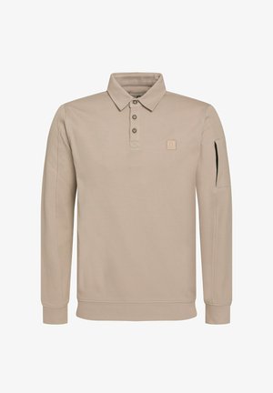 Beżowa polo z długim rękawem, z trzema guzikami, logo na piersi i boczną kieszenią na zamek. Materiał jest miękki i teksturowany. Klasyczny kołnierzyk.