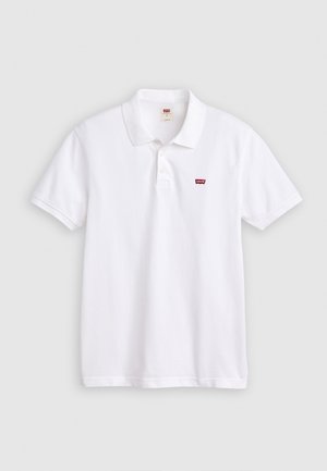 Baltas medvilninis polo marškinėliai su klasikine apykakle, trimis mygtukais ir mažuoju raudonu logotipu ant kairiojo krūtinės. Trumpomis rankovėmis.