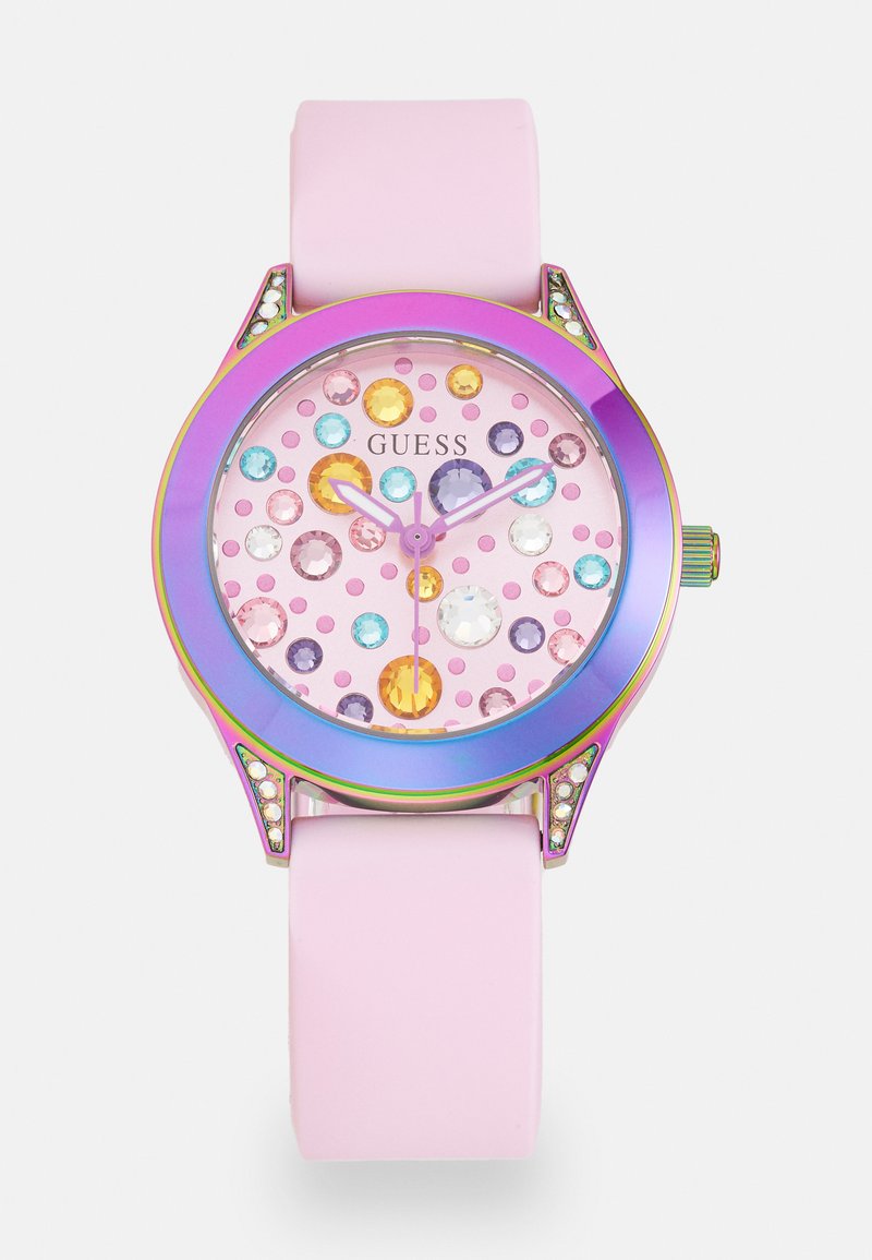 Pink rubber watch with a circular face featuring multicolored gems and polished hands. The bezel has a rainbow finish and decorative accents.