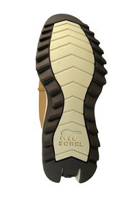 Guma podeszwy buta Sorel z głębokim bieżnikiem, teksturowanym beżowym środkiem i wytłoczonym logo niedźwiedzia w pobliżu pięty.