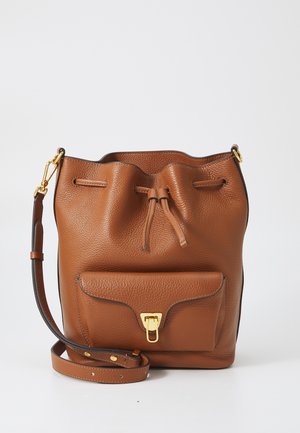 Brown leather bucket bag with a pebbled texture, adjustable strap, drawstring closure, and a front pocket with a gold clasp detail.