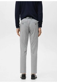 Gray tailored trousers with a fitted design, featuring two back pockets and belt loops. Worn with black shoes, displayed from the back.