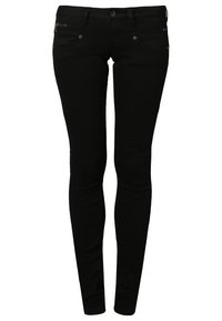 Jeans skinny negros hechos de denim elástico, con diseño de cinco bolsillos, cremallera frontal y sutiles acentos metálicos.