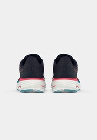 Blue and pink running shoes with a mesh upper and padded collar. Thick white sole with a textured blue outsole. Reflective accents on the back.