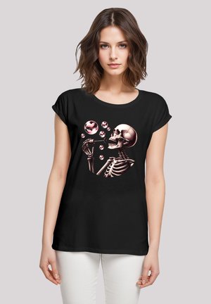 Black t-shirt featuring a skeleton graphic blowing pink bubbles. Includes short sleeves, round neckline, and a relaxed fit.