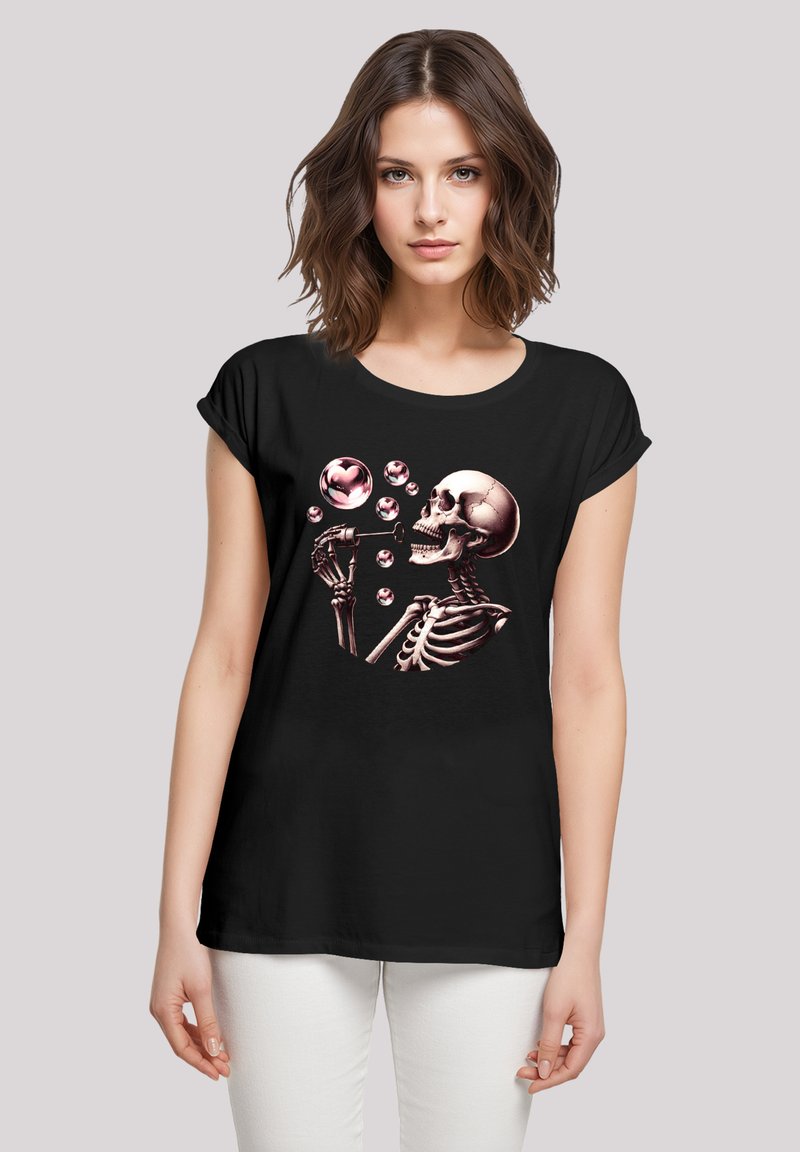 Schwarzes T-Shirt mit einem Skelett-Graphik, das pinke Blasen bläst. Es hat kurze Ärmel, einen runden Ausschnitt und eine lockere Passform.