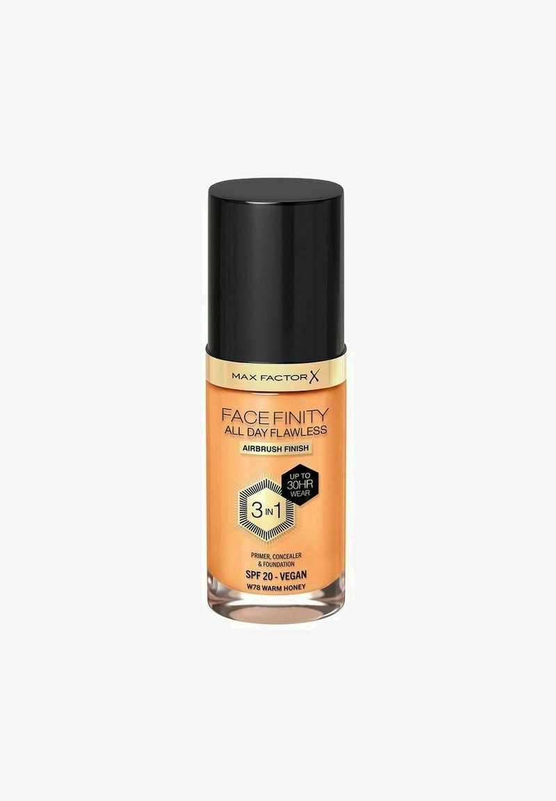 Max Factor Face Finity foundation i en klar glasflaske med et sort låg. Orange etiket med tekst, sekskantet design og SPF 20 detalje.