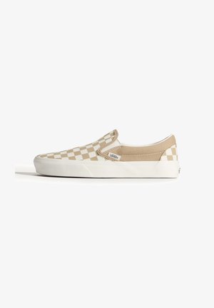 Beżowo-białe slip-on Vans w kratkę z białą gumową podeszwą i logo marki z boku, pokazane w profilu z prawej strony.