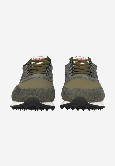 Olive green sneakers with textured fur accents, gray panels, black laces, and a white rubber sole featuring a tread pattern.