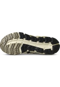 Semelle de chaussure de course avec un design courbé, en caoutchouc noir texturé et accents beiges. Offre une adhérence avec plusieurs motifs de crampons.