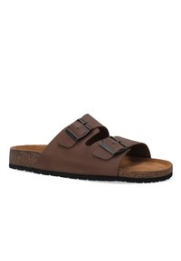 Brown leather slide sandal features two adjustable buckles, a contoured cork footbed, and a textured black rubber outsole.