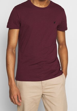 Burgunderfarbenes T-Shirt mit kurzen Ärmeln aus weicher Baumwolle, mit Rundhalsausschnitt und kleinem schwarzem Logo auf der Brust.