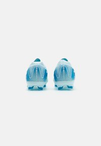 Blue soccer cleats feature a lightweight design, textured upper with white striped patterns, and a molded outsole with multiple traction studs.