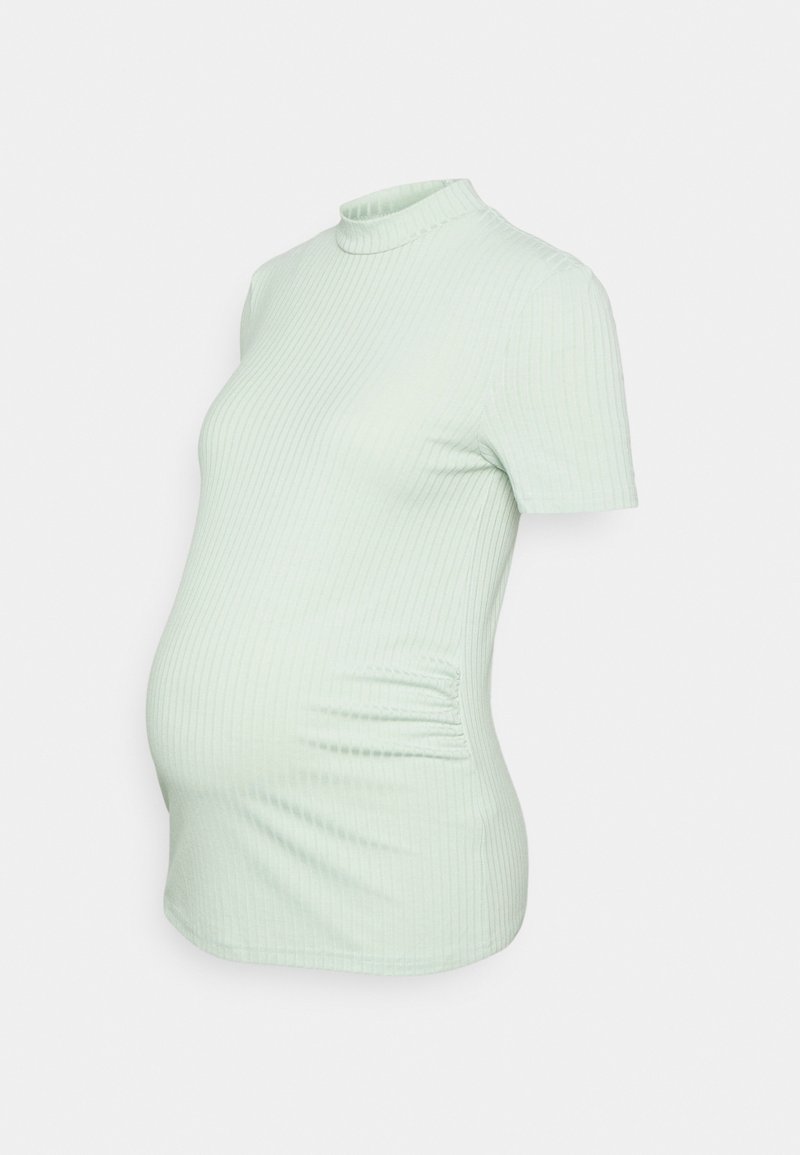 Top de maternidade em verde menta claro com textura canelada, gola alta, mangas curtas, forma ajustada e detalhe de franzido lateral para maior conforto.