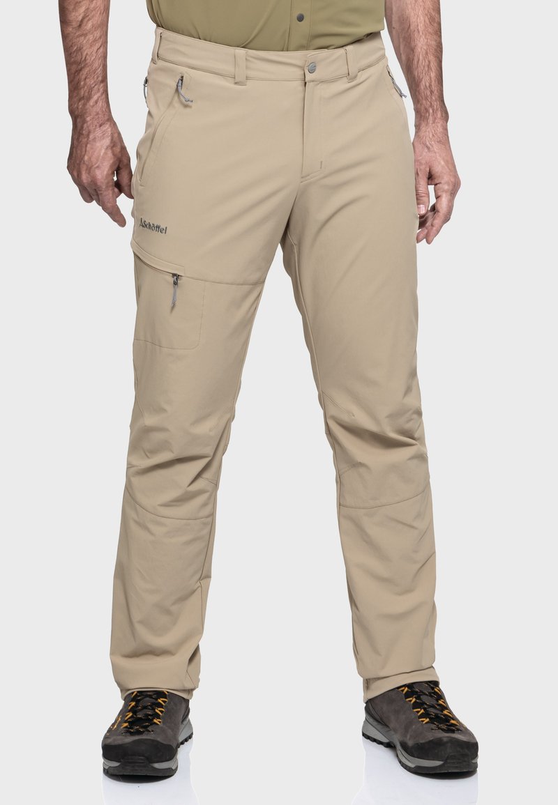 Beige Outdoor-Hosen mit Reißverschlusstaschen, aus leichtem Material gefertigt. Mit elastischem Bund und schmal zulaufendem Bein für zusätzlichen Komfort.