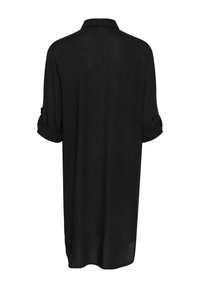 Chemise en lin noire avec col, manches courtes retroussées et coupe ample. L'arrière est uni avec un ourlet légèrement arrondi.