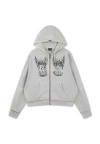 Light gray zip-up hoodie with front pockets, featuring black skeleton winged figures and flame designs on the chest and subtle patterns on sleeves.
