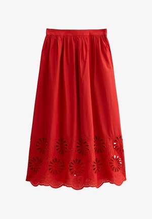 Red cotton skirt with a gathered waistband and floral cut-out pattern at the hem, featuring scalloped edges for added detail.