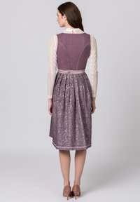 Purple dress with a fitted bodice and a pleated skirt featuring floral patterns, paired with a white lace long-sleeve blouse and high heels.