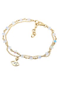 Guldring med klara kristallpärlor formade som diamanter, med en liten ögoncharm fäst, säkrad med en kräftklor-lås.