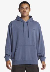 Hooded sweatshirt in slate blue, featuring a front kangaroo pocket, long sleeves, ribbed cuffs, and a small logo on the chest. Soft texture.