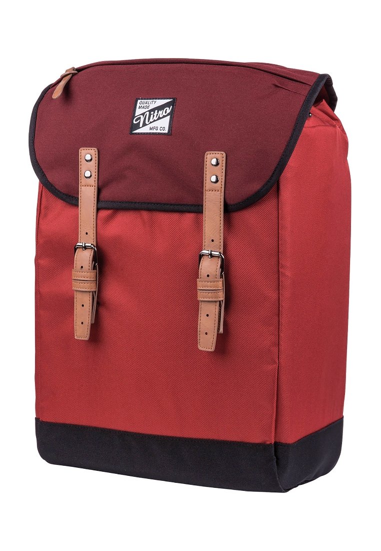 Roter Stoffrucksack mit schwarzem Boden, ausgestattet mit braunen Lederträgern, einem Klappenverschluss und einem Logo-Patch auf der Vorderseite.