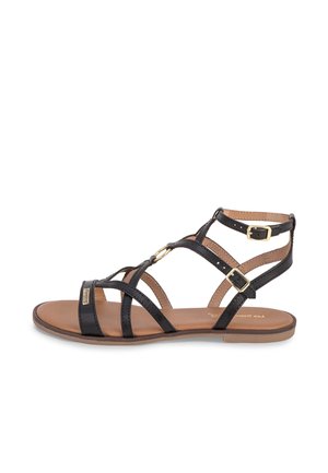 Sandale en cuir noir avec plusieurs lanières et accents dorés. Semelle plate et bride à la cheville avec boucle. Présente un design lisse et minimaliste.