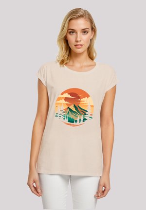 Light beige t-shirt with short sleeves featuring a colorful graphic of mountains and trees against a sunset background.