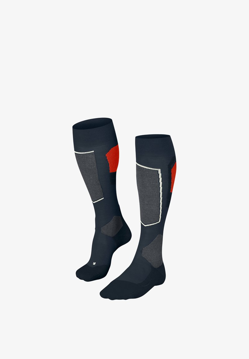 Chaussettes marine avec des accents gris et rouges, dotées de panneaux texturés et de zones renforcées pour un amorti. Le design comprend des coutures contrastantes.