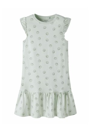 White sleeveless children's dress with small grey seashell patterns and a ruffled hem.