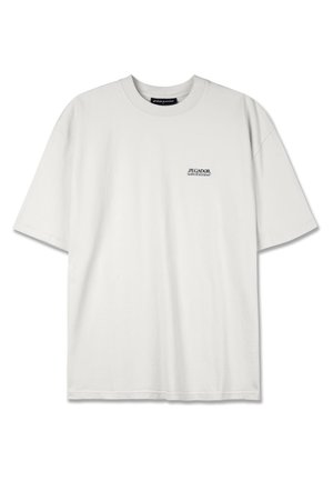 White cotton t-shirt with a round neck, short sleeves, and a small black printed logo on the left chest, featuring a relaxed fit.