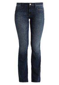 Granatowe dżinsy o zwężanym kroju i wyblakłym przodzie. Posiadają zapięcie na guzik i zamek oraz standardowe kieszenie. Gładka tekstura.